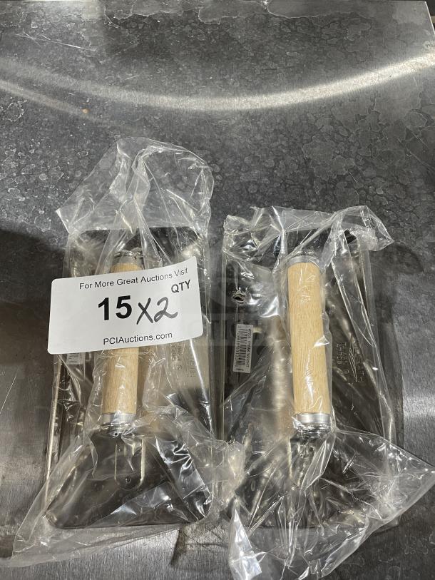 Brand new VollRath stainless steel steak weight, model 47703, with wood handle in packaging, auction label visible.