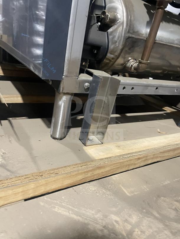 Champion 44PRO commercial stainless steel conveyor dishwasher, brand new, on legs, with full-size dish rack and built-in booster.