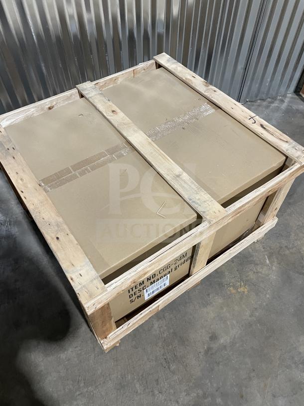 Cookline CGG24M commercial stainless steel gas griddle, brand new, boxed in a wooden crate, model and serial number visible.