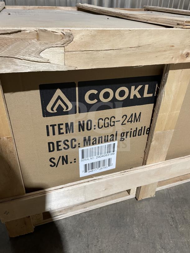 Brand new Cookline CGG24M stainless steel gas griddle with manual controls, back and side splash. Serial: 2404093199.