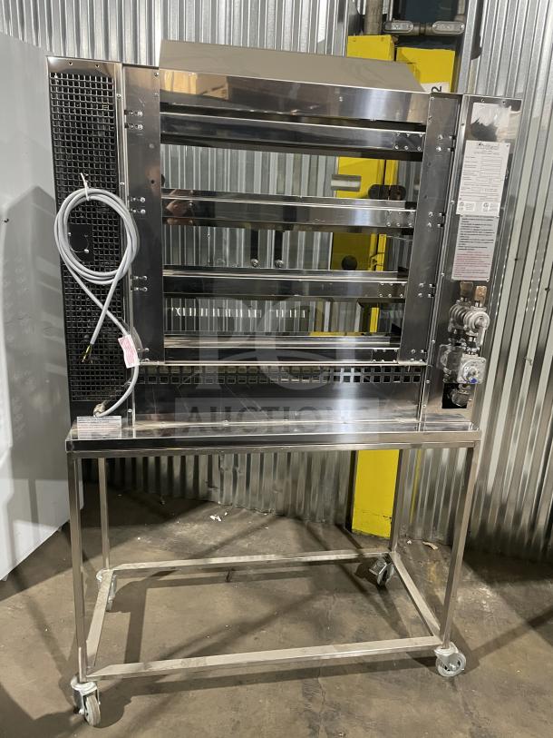 Rotisol 1160.4 stainless steel rotisserie oven, brand new, natural gas powered, tempered glass doors, on casters.