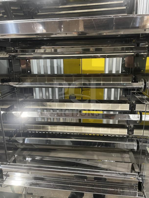 Brand new Rotisol 1160.4 stainless steel rotisserie oven, natural gas, tempered glass doors, on casters, with serial number 9409.