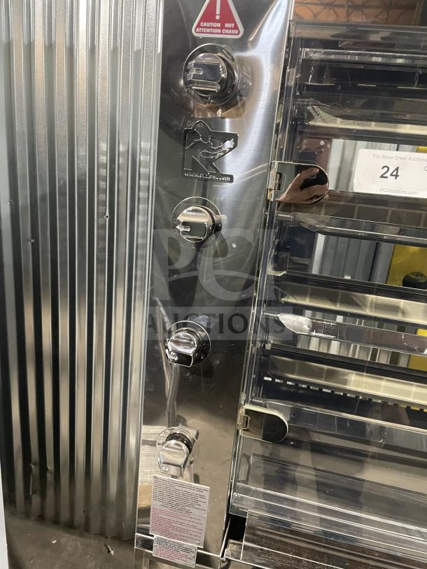 Rotisol 1160.4 stainless steel rotisserie oven, natural gas, tempered glass doors, new condition, with casters and safety labels.