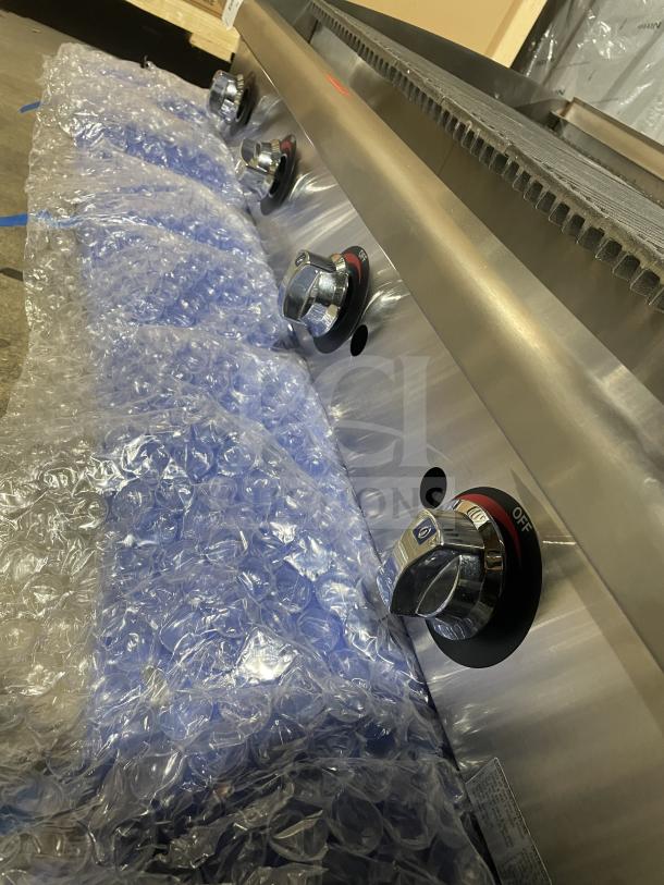 "Star Max Series gas char broiler, stainless steel, cast iron grates, back/side splash, new condition with protective wrap."