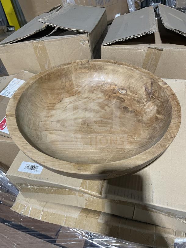 Brand new mixed pallet showing a large wooden bowl atop cardboard boxes, includes varied kitchen and commercial items.