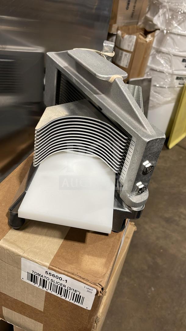 Brand new Nemco 55600-1 tomato slicer with stainless steel blades, on legs, in original box with label visible.