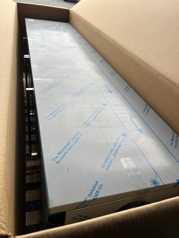 Brand new Perlick BBS108RFYSSH1 commercial black 4-door bar back refrigerator, in box, with stainless steel worktop.