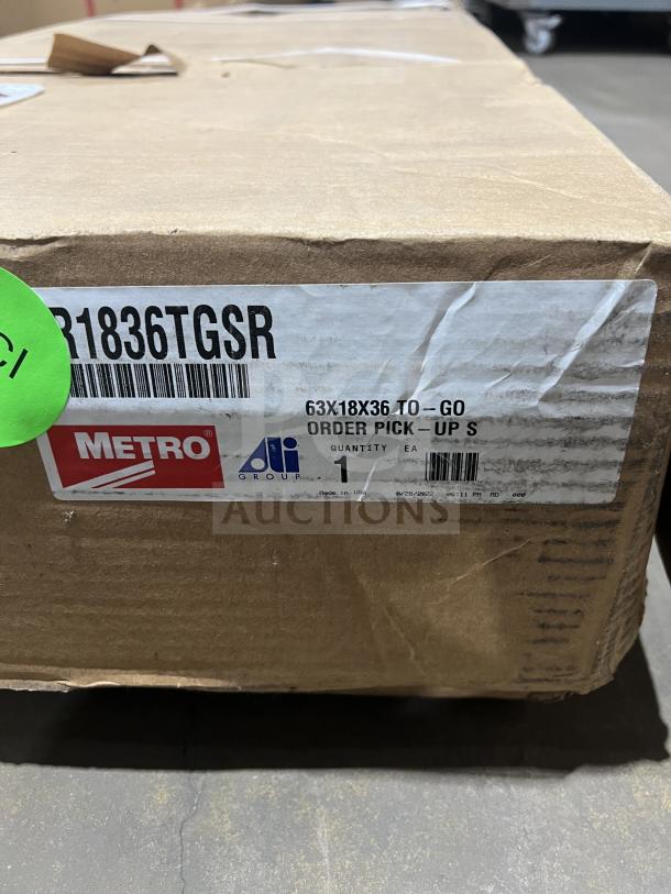Brand new Metro 36" stainless steel wire shelving, model CR1836TGSR, in box. Serial number: 10279781. On legs.