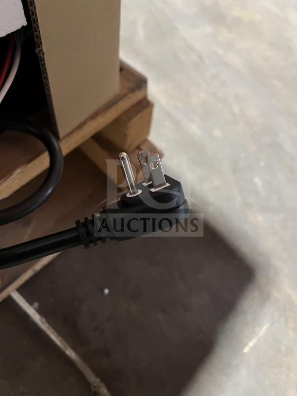 Power cord for Turbo Air Commercial Black 2-Glass Door Bar Back Cooler, model TBB2448SGDN, shown resting on a wooden pallet.
