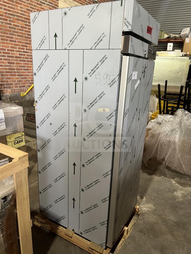Brand new Hoshizaki F1AFS stainless steel one-door reach-in freezer, with wired racks, protective covering intact. Model: F1A-FS, SN: M53952B.