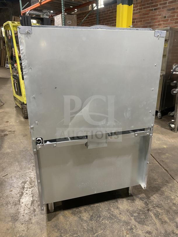 Back view of Kutano commercial 36" 6-burner range/oven, model KUT6BRN36N6, showing stainless steel finish and dent.