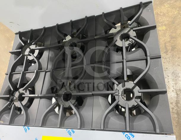 Brand new Kutano 36" 6-burner gas range/oven, model KUT6BRN36N6, stainless steel, on legs, slight scratch and dent.