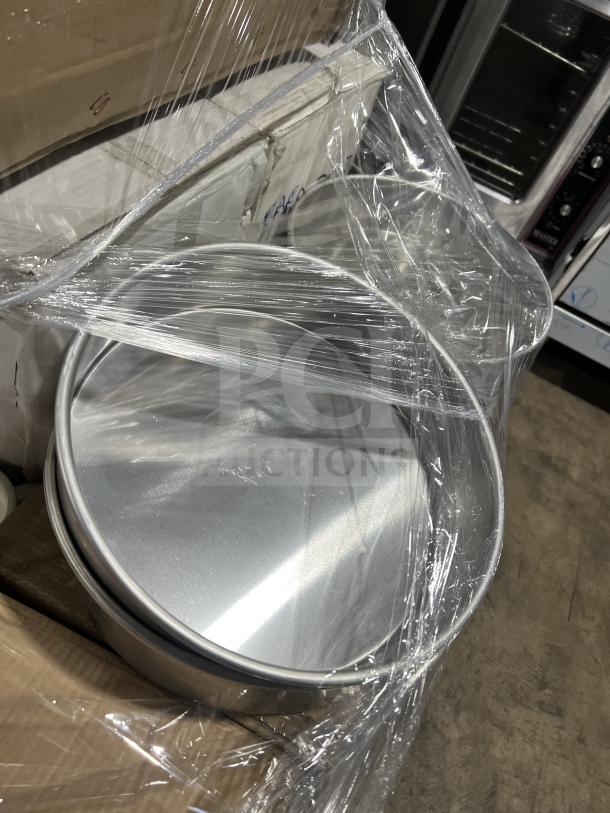 Pallet of new commercial kitchenware, including onion soup crocks, Hartford mugs, fruit dishes, deep platter plates, and cake pans.