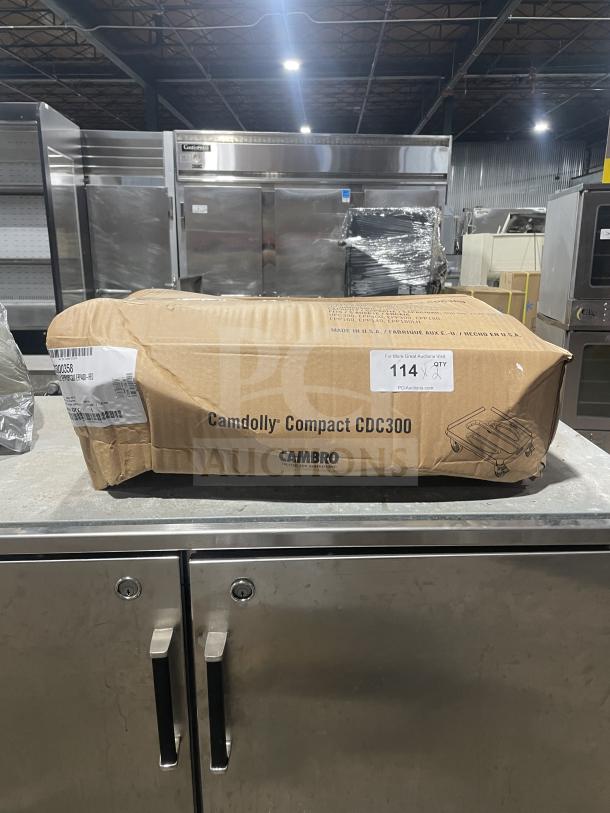 Brand new Cambro CDC300358 hot red compact dolly in original box, labeled with model and serial number, unopened.