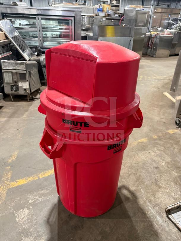 New Brute heavy-duty red poly trash can with dome push cover. Features durable construction and branded logo.
