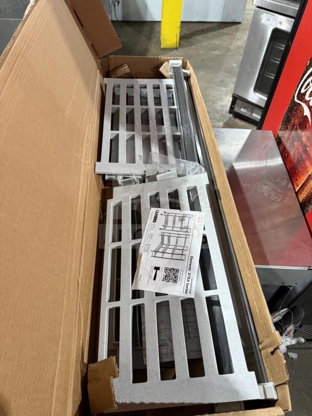 New Cambro Cam shelving unit in box, with assembly instructions visible. Made of durable materials, ideal for storage.