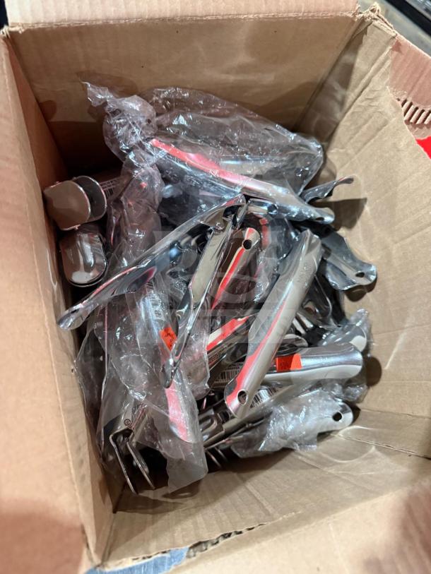 New in box hand-held nut crackers, metal, multiple units, packaged in plastic, for auctions or sales.