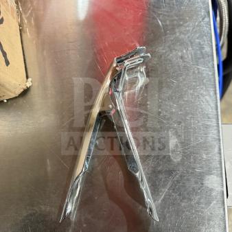 New In Box hand-held nut cracker, shiny chrome finish, unused condition, ergonomic grips, suitable for various nuts.