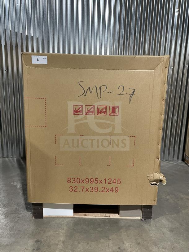 Brand new Coldline SMP27 refrigerated prep table in box, on casters. Model and dimensions marked on packaging.