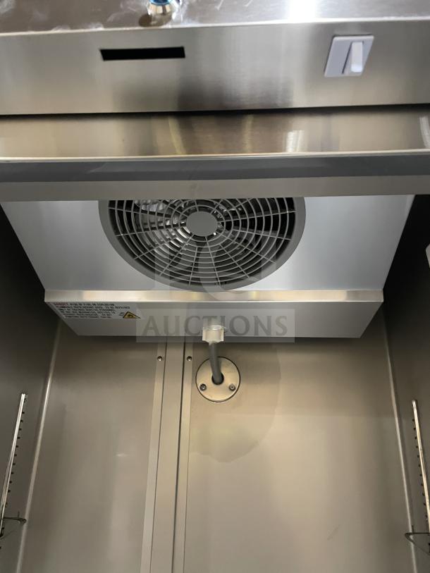 Coldline C19F Stainless Steel Reach-In Freezer interior, showcasing ventilation fan and wired rack. New condition.