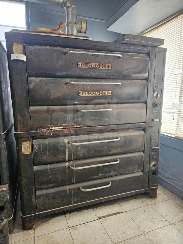 Blodgett 981 natural gas double deck oven, showing signs of wear and tear, with visible brand labels on both decks.