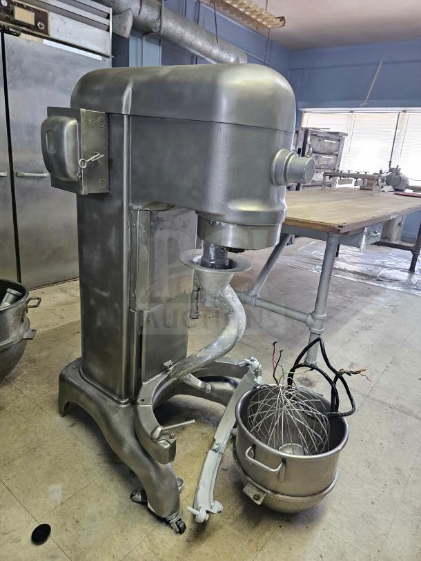 Hobart 60Qt commercial mixer with attachments, including whisk and bowl. Sturdy condition; ideal for high-volume kitchens.
