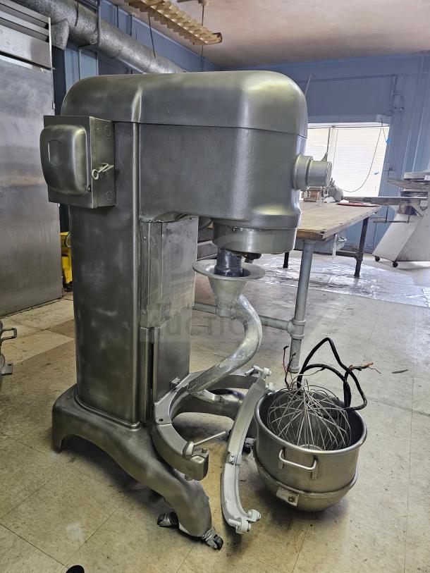 Hobart 60Qt commercial mixer with attachments, including dough hook, whisk, and bowl; silver finish, industrial condition.