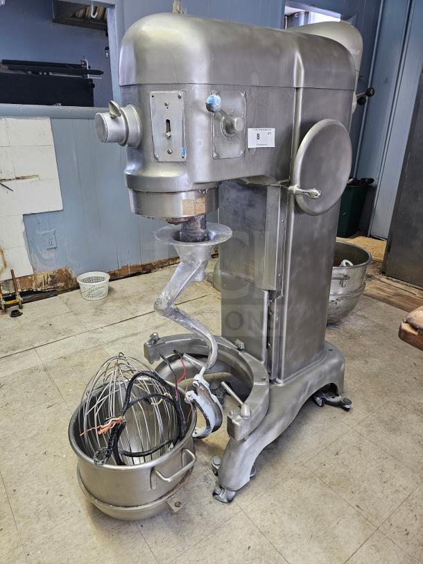 Hobart 60Qt commercial mixer with attachments, stainless steel, in used condition. Model and controls visible. Includes whisk.