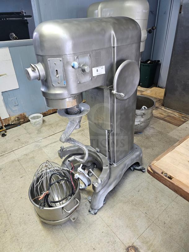 Hobart 60Qt commercial mixer with attachments, stainless steel, sturdy condition. Includes whisk and bowl. Visible markings panel.