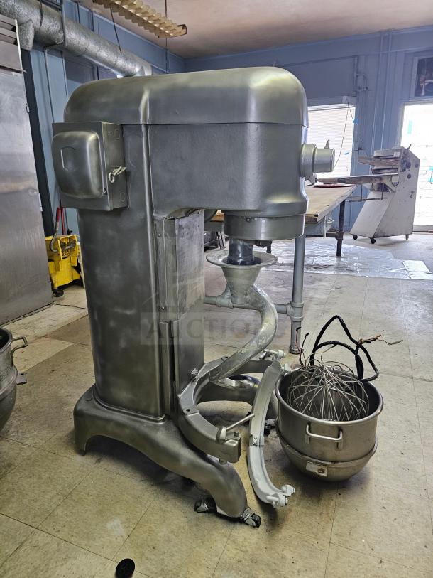 Hobart 60Qt commercial mixer, silver finish, includes bowl, whisk, and dough hook. Industrial-grade, used condition.