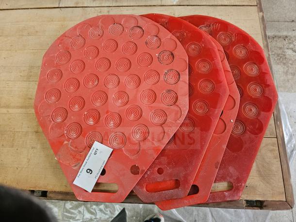 Red industrial bakery divider-rounder molding plates with circular patterns, slight wear, auction tag visible, used for dough shaping.