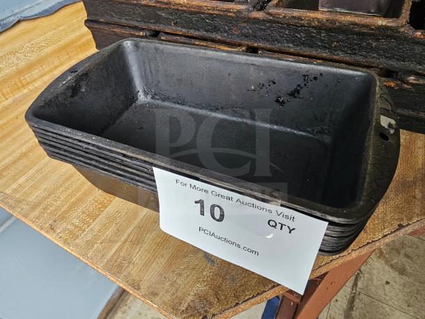 Large black baking pan with visible wear, rectangular shape, and a label showing "10 QTY" with auction website details.