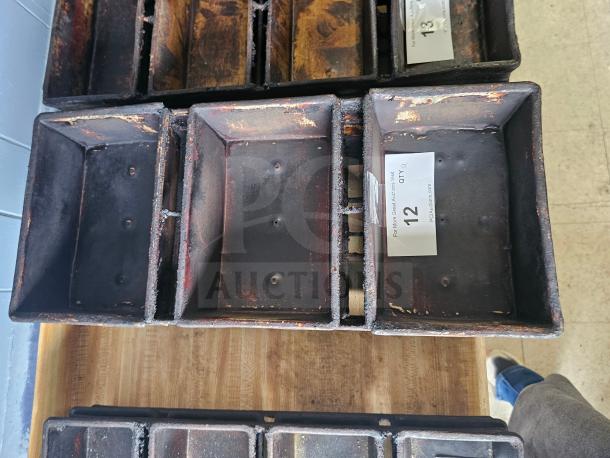 Rustic baking pan with visible wear, multi-loaf design, and auction label reading "12 QTY 4" from PICIauctions.com.