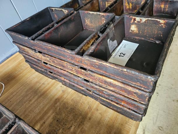 Stack of vintage rectangular baking pans with tarnished surface, showing wear. Label indicates quantity 12, for auction.