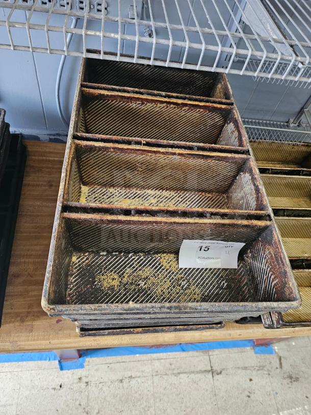 Rectangular metal baking pan with three sections, showing signs of wear and rust. Auction tag number 15 attached.