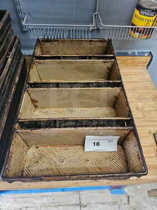 Vintage industrial baking pan with four compartments, used condition, metal with ribbed texture, auction tag number 16.