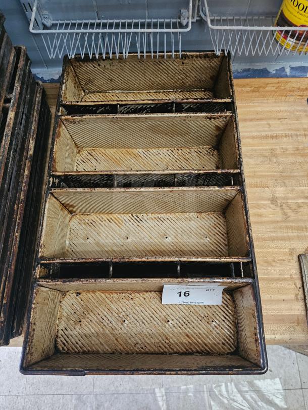 Vintage baking pan with three sections, worn condition, visible rust and patina, item tag labeled "16" from PCIAuctions.com.