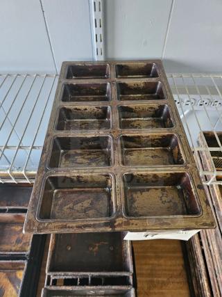 Vintage metal baking pan with twelve slots, well-worn patina, rectangular shape, ideal for crafting or kitchen use.