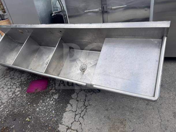 Stainless steel 3 bay sink, commercial grade, with integrated drains, fair condition, ideal for kitchen use.