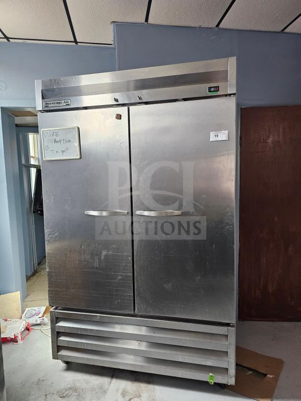 Beverage-Air KR48-1AS refrigerator, 2 solid doors, stainless steel, note on front. Used, visible wear.