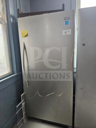 FRIGIDAIRE single door freezer, silver, visible scratches, energy-efficient label, inventory tag "21", upright model.