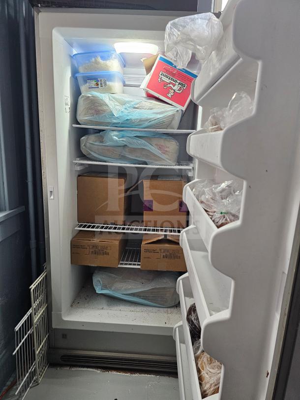 Frigidaire single door freezer with shelves filled with various food items. Appears in used condition.