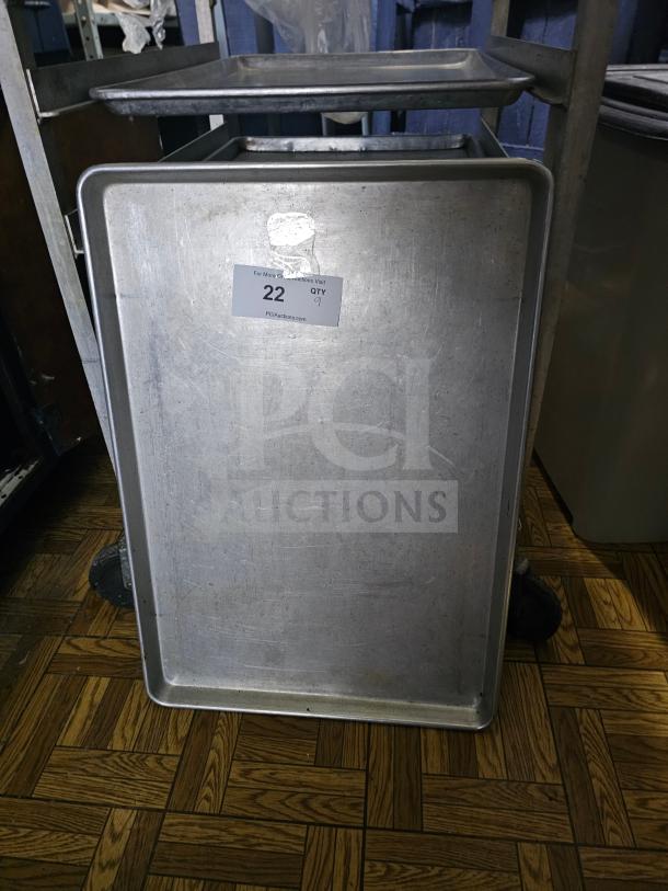 Full-size metal baking pan, used, with visible wear. Auction label showing "22" and quantity "9" from PCI Auctions.