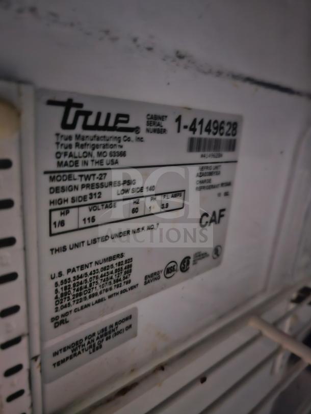 TRUE TWT-27 Sandwich Table label, showing model, serial number, design pressures, and compliance markings.