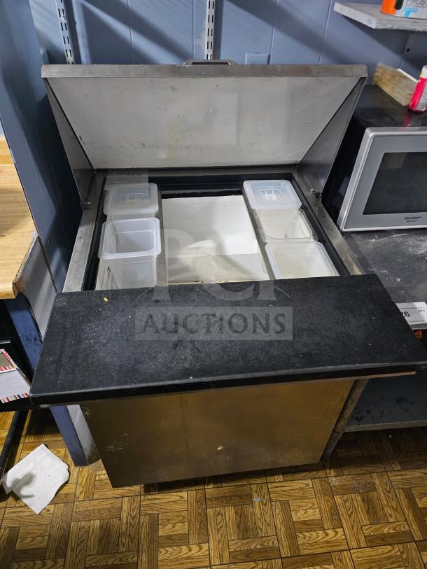 TRUE TWT-27 Single Door Sandwich Table with open top, interior bins, and stainless steel exterior. Used condition.