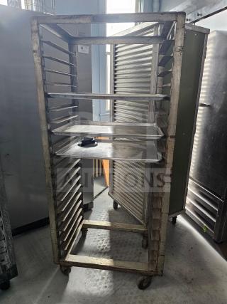 Aluminum sheet pan rack with multiple slots, used condition, on wheels for easy mobility. Suitable for commercial kitchens.