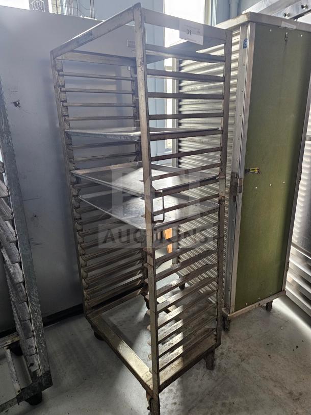 Aluminum sheet pan rack with multiple tiers, lightly worn, industrial design, ideal for restaurant or bakery use.