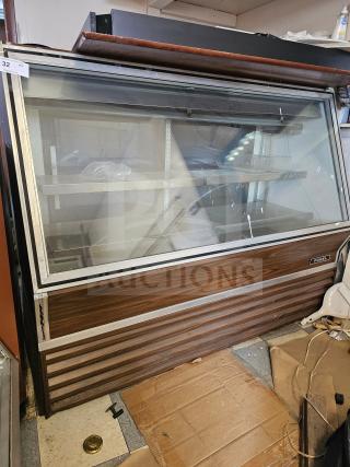 Fogel refrigerated deli display case, showing several signs of wear and non-functional condition, with a visible Fogel label.