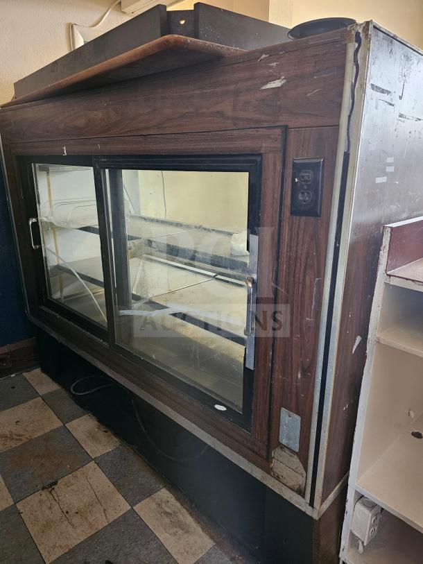 Fogel refrigerated deli display case, wood finish, glass sliding doors, several signs of wear, non-functional condition.