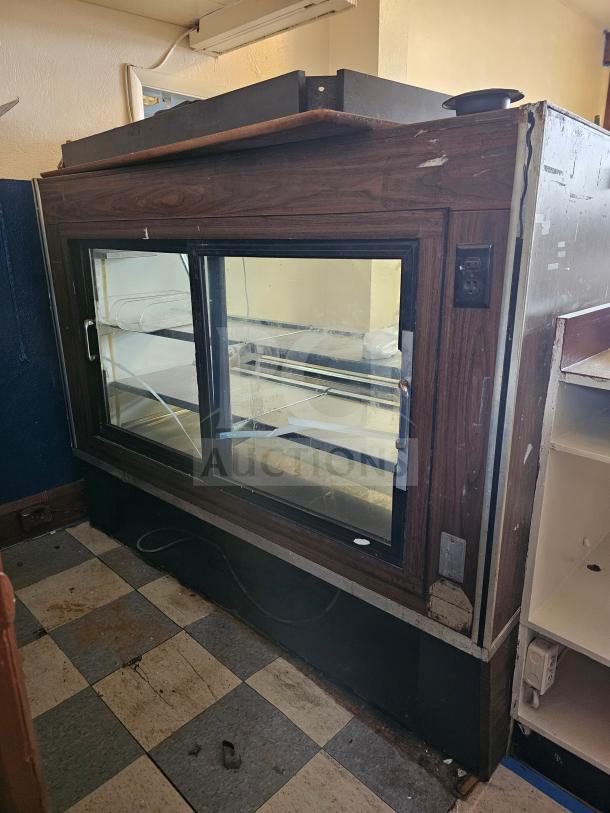 Fogel refrigerated deli display case, several signs of wear, wood finish, non-functional, glass doors, interior shelves.